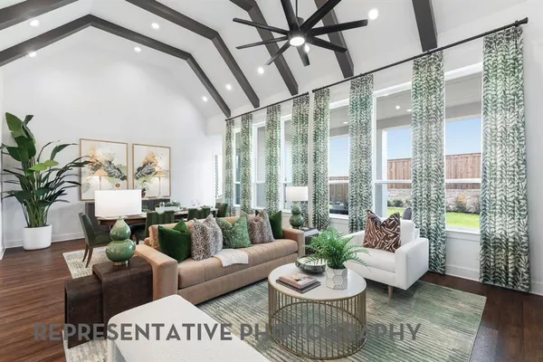 a living room with furniture and floor to ceiling windows