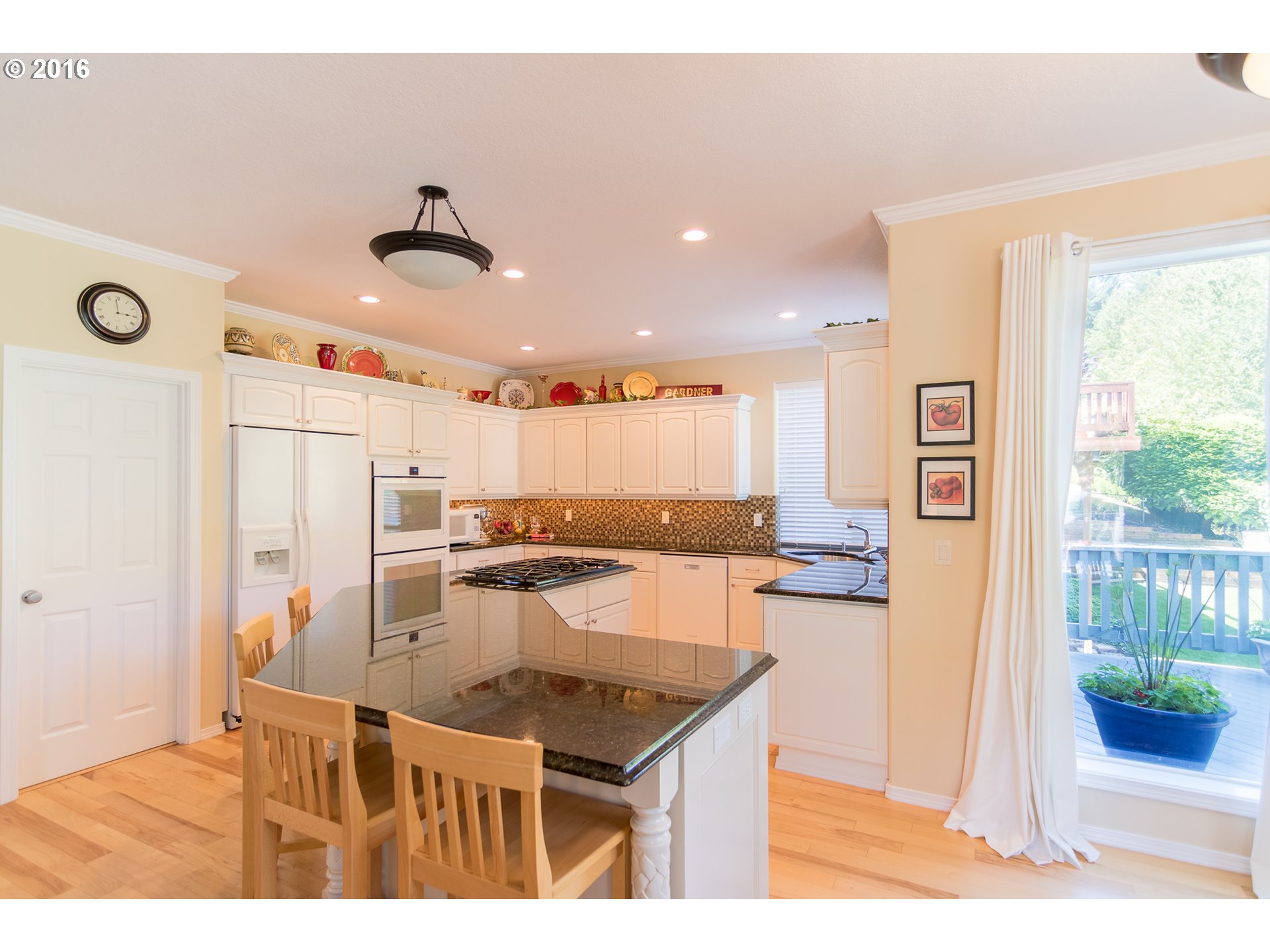 15806 Southwest Colyer Way Tigard, OR 97224 - Photo 11 of 32 a kitchen with a sink refrigerator and microwave