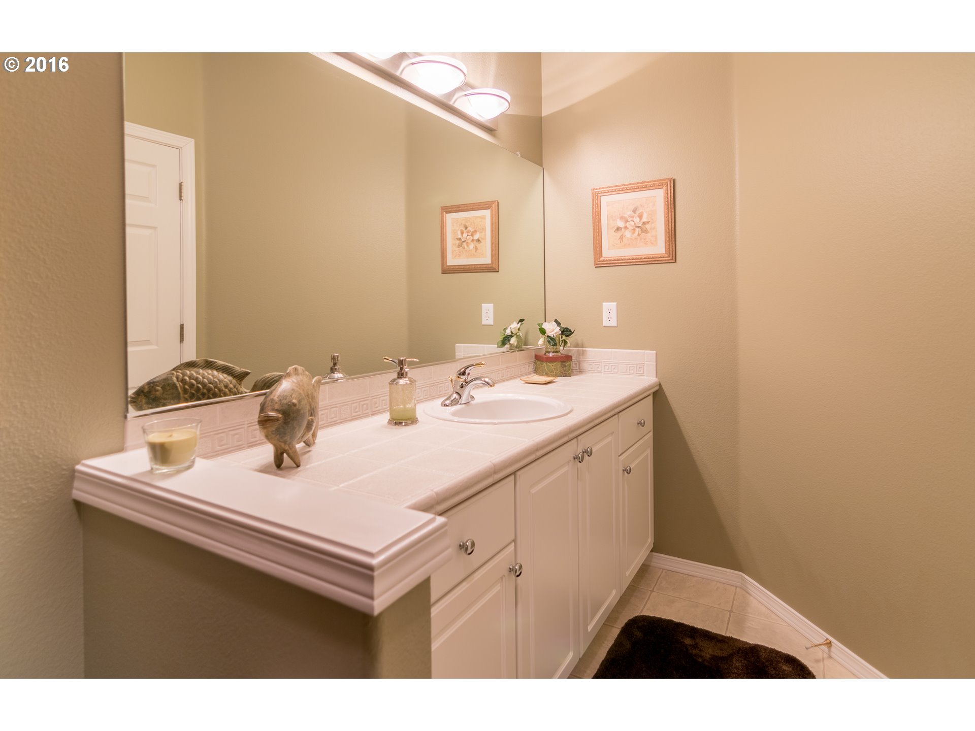15806 Southwest Colyer Way Tigard, OR 97224 - Photo 16 of 32 a bathroom with a sink and a mirror