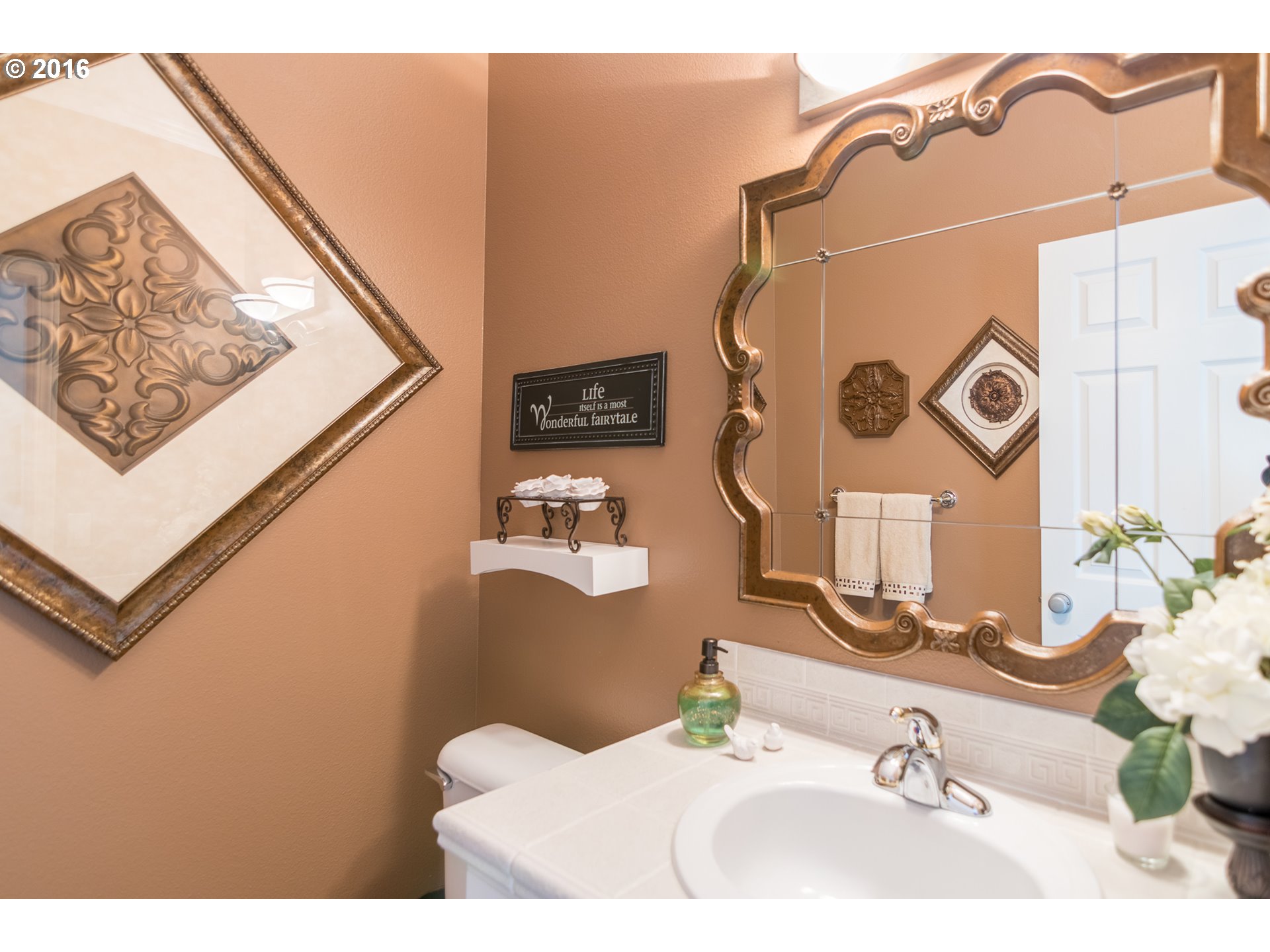 15806 Southwest Colyer Way Tigard, OR 97224 - Photo 3 of 32 a bathroom with a sink and mirror