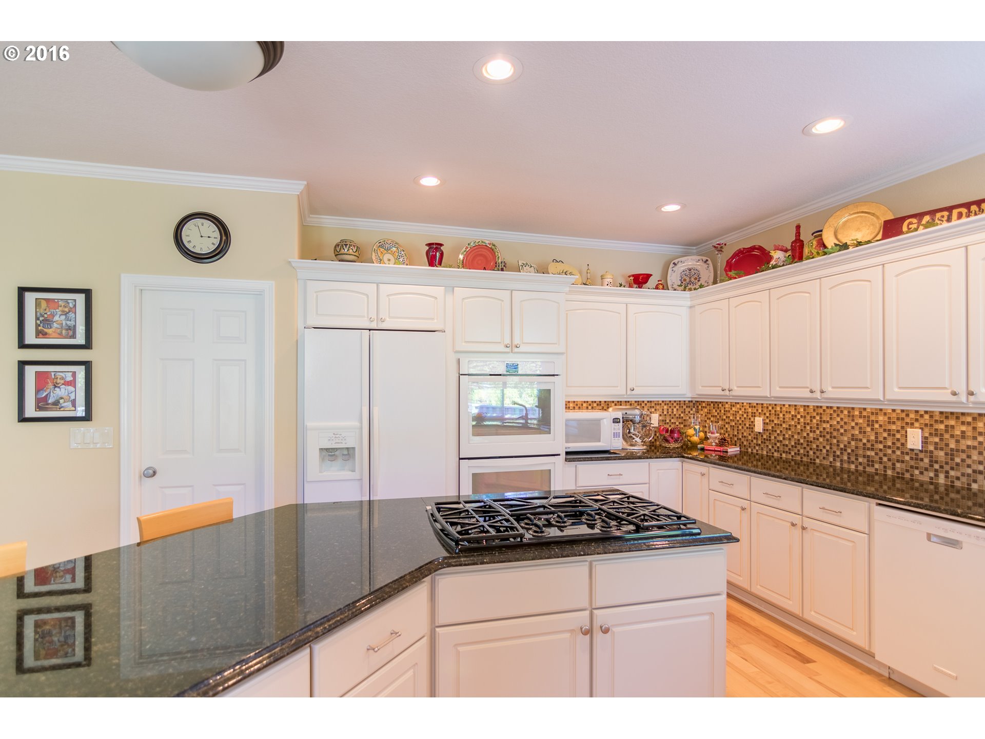 15806 Southwest Colyer Way Tigard, OR 97224 - Photo 10 of 32 a kitchen with granite countertop a stove a sink and a refrigerator