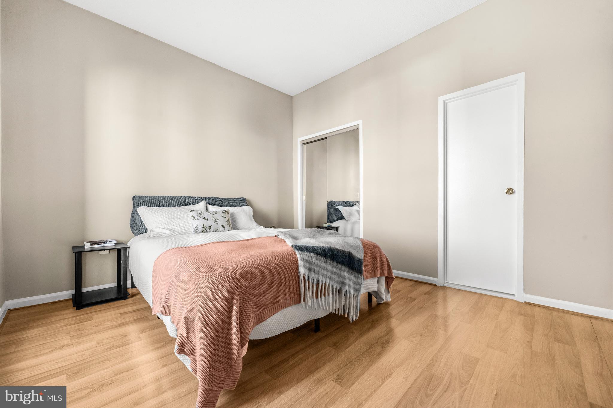 1851 Columbia Road Northwest, Unit 401 Washington, DC 20009 - Photo 16 of 27 a bedroom with a bed and wooden floor