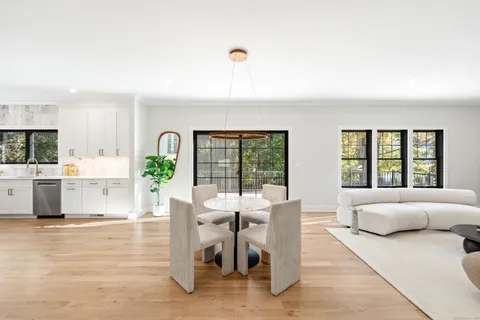 a living room with furniture windows and wooden floor