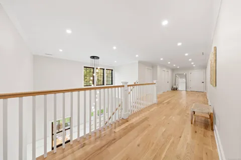 a view of hallway with wooden floor