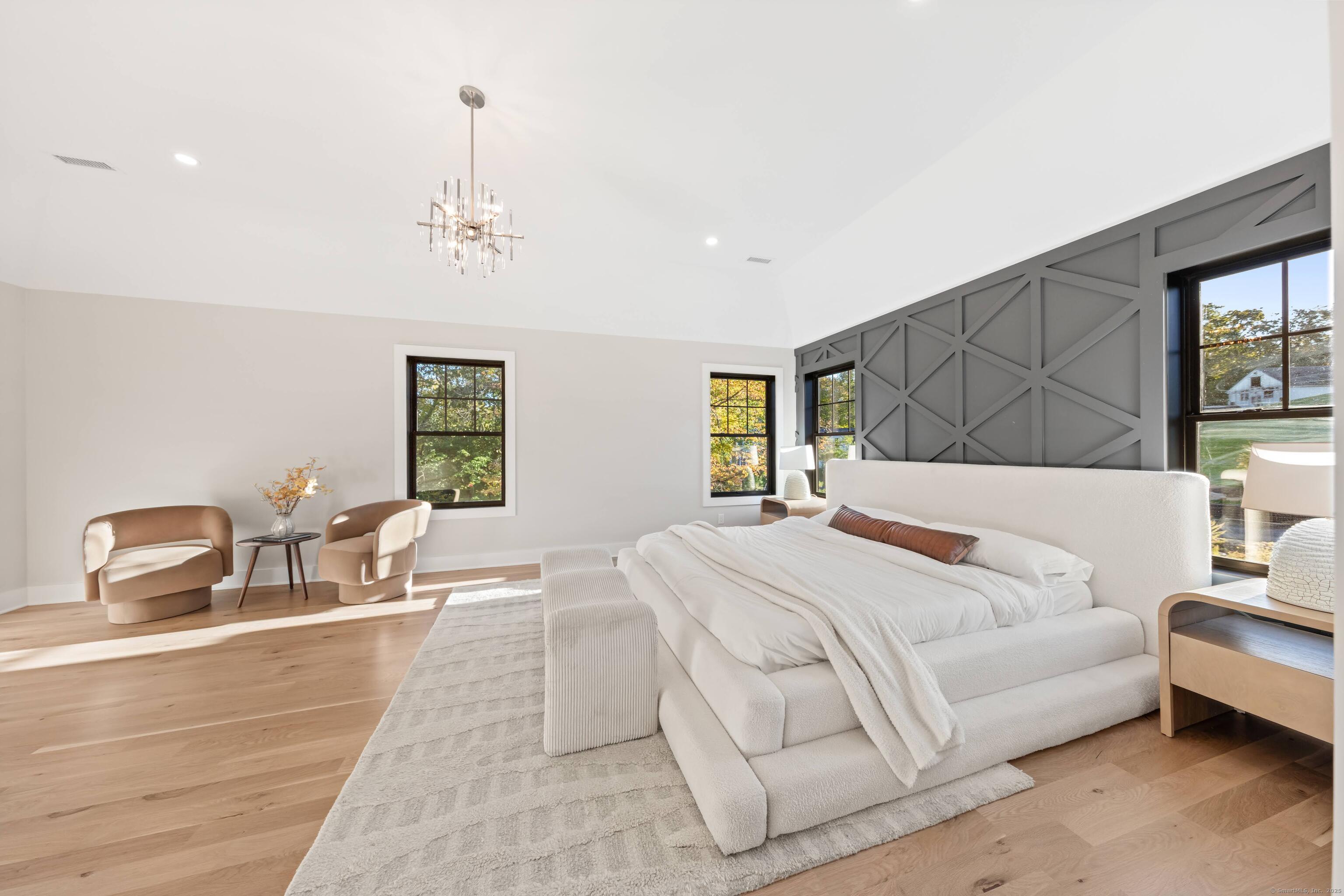 31 Gray Farms Road Stamford, CT 06905 - Photo 22 of 40 Welcome to your primary bedroom with vaulted ceilings, a separate space for a sitting area in the room, great light, 2x walk-in closets, and a large primary bathroom