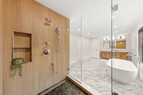 a bathroom with a tub and shower