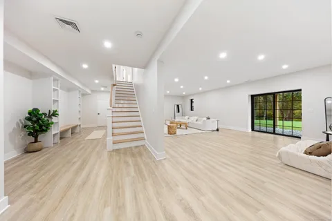 a view of a hallway with wooden floor