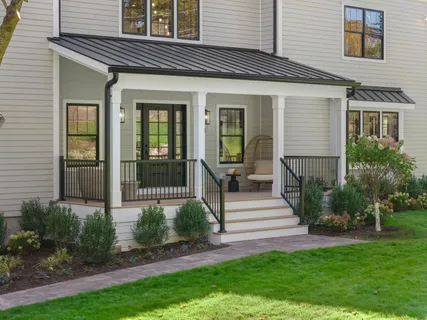 a front view of a house with a yard porch and glass windows