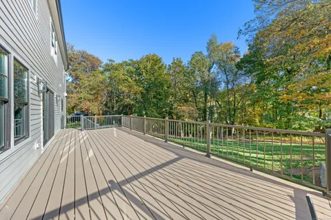 a view of a house with a big yard and large trees