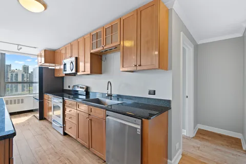 a kitchen with stainless steel appliances granite countertop a sink stove and cabinets