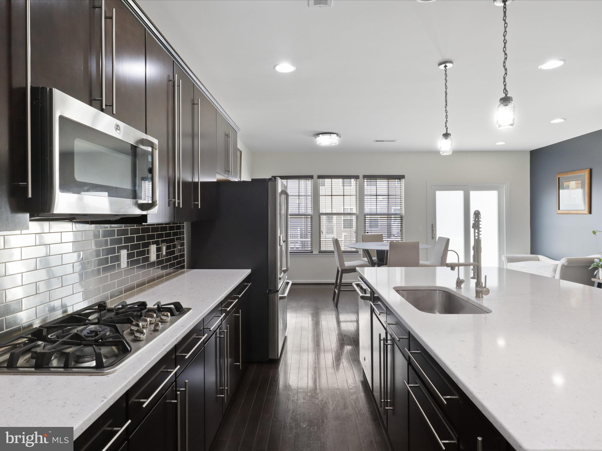 44021 Eastgate View Drive Chantilly, VA 20152 - Photo 11 of 30 a kitchen with granite countertop lots of counter top space a sink stainless steel appliances and windows