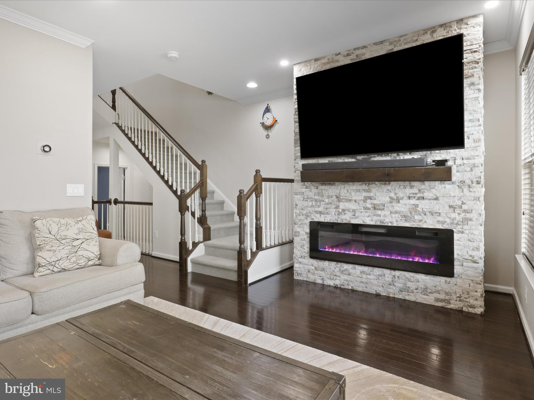44021 Eastgate View Drive Chantilly, VA 20152 - Photo 16 of 30 a living room with furniture a flat screen tv and a fireplace