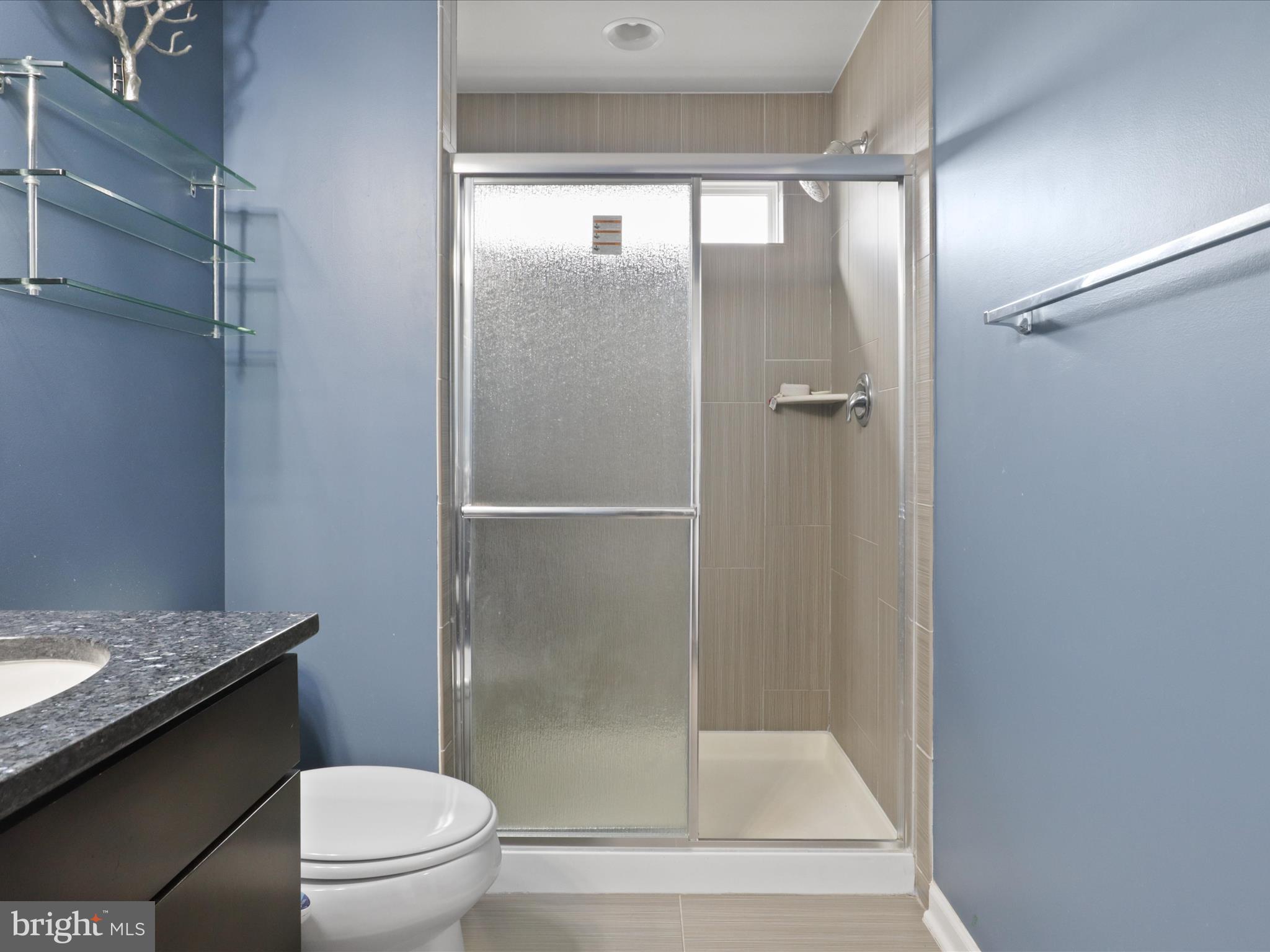 44021 Eastgate View Drive Chantilly, VA 20152 - Photo 19 of 30 a bathroom with a granite countertop mirror toilet and sink