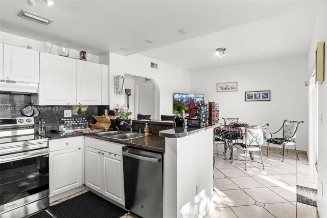 a kitchen with a sink and cabinets
