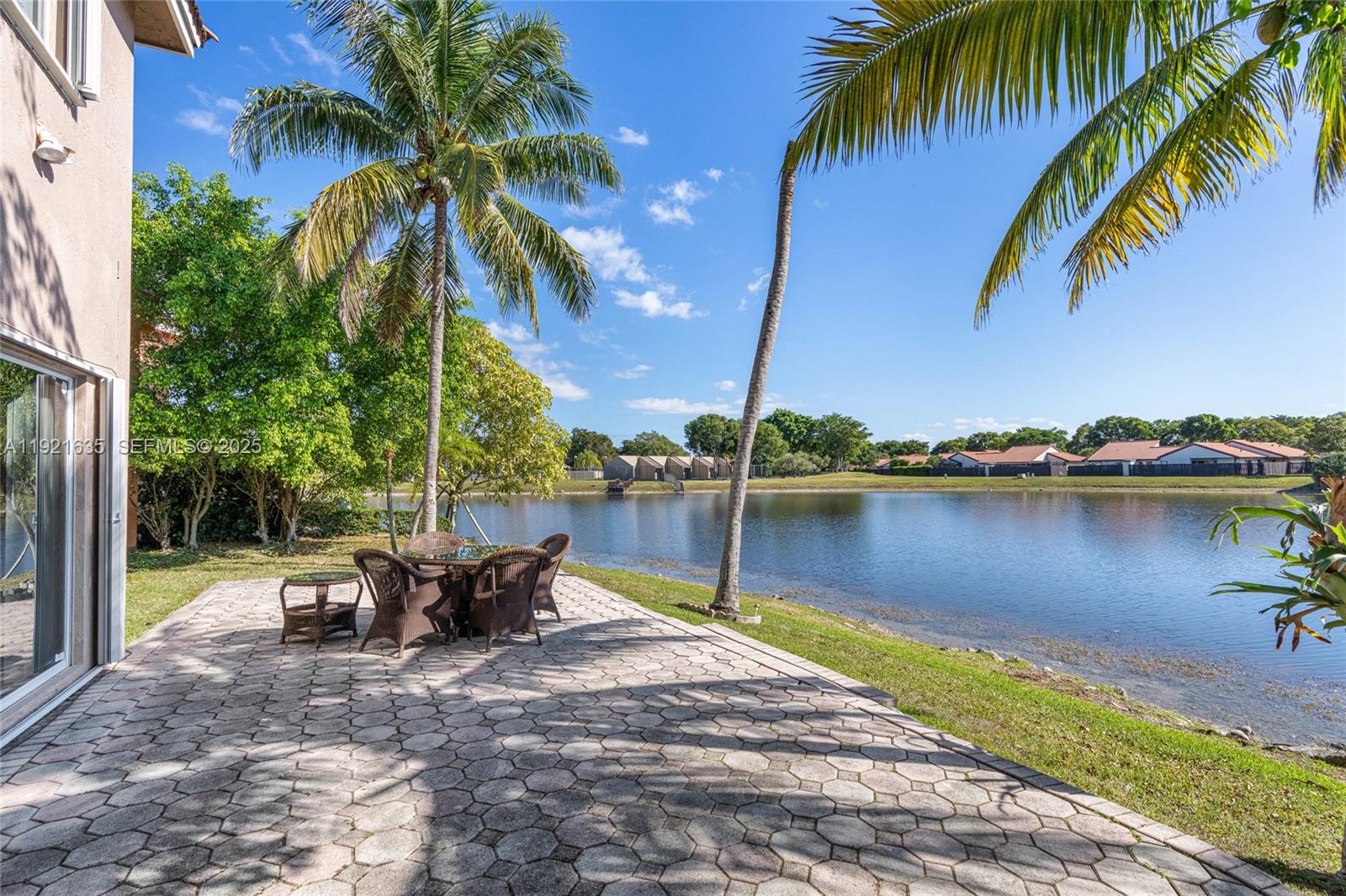 4687 Southwest 153rd Court Miami, FL 33185 - Photo 2 of 40 a view of a lake with a table and chairs