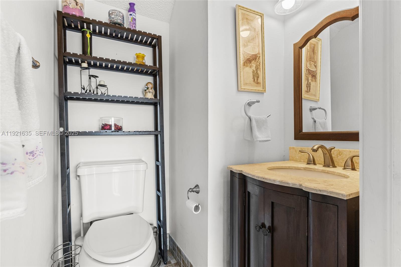 4687 Southwest 153rd Court Miami, FL 33185 - Photo 22 of 40 a bathroom with a granite countertop toilet sink and mirror