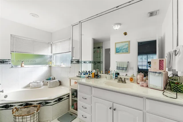 a bathroom with a sink double vanity and a mirror