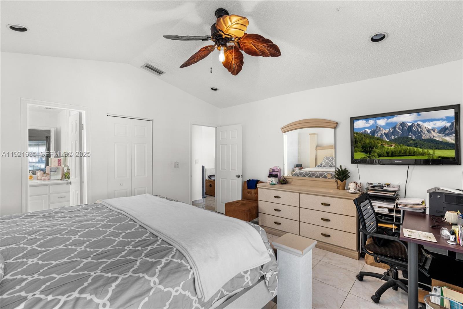 4687 Southwest 153rd Court Miami, FL 33185 - Photo 27 of 40 a bedroom with a large bed and a flat screen tv