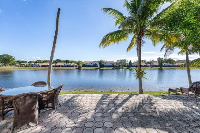 a view of a lake with a table and chairs
