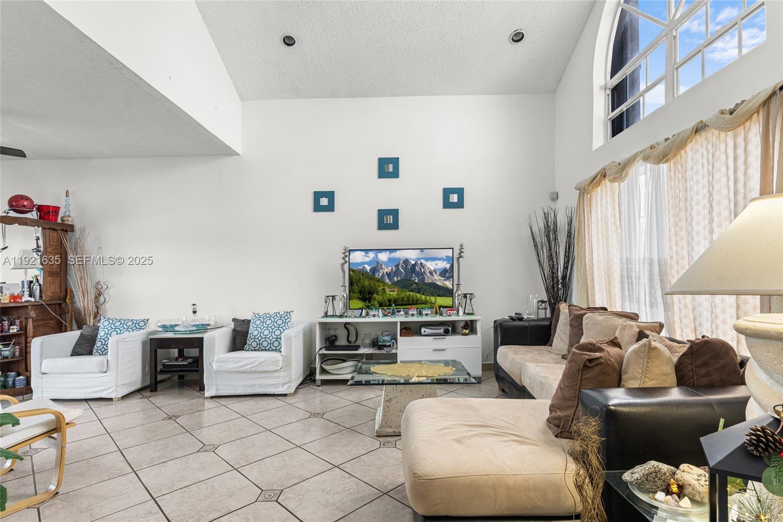 4687 Southwest 153rd Court Miami, FL 33185 - Photo 8 of 40 a living room with furniture and a flat screen tv