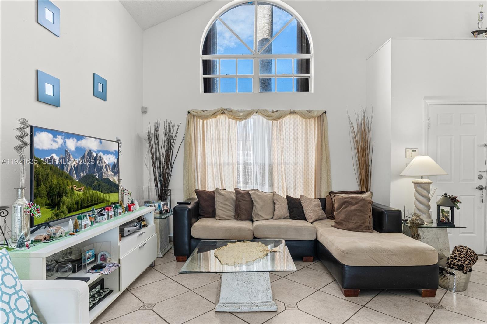 4687 Southwest 153rd Court Miami, FL 33185 - Photo 10 of 40 a living room with furniture and a flat screen tv