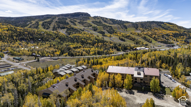 150 Ridgeview Street Brian Head, UT 84719 - Photo 33 of 43 Mountain landscape with ski slopes, multiple buildings with sloped roofs, and surrounding deciduous trees
