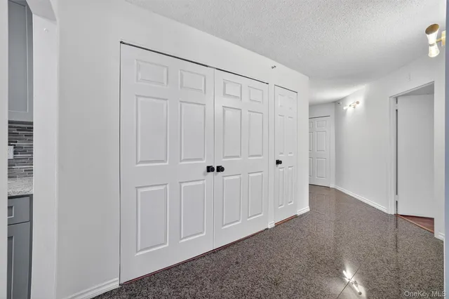 a view of a kitchen with refrigerator and wooden floor
