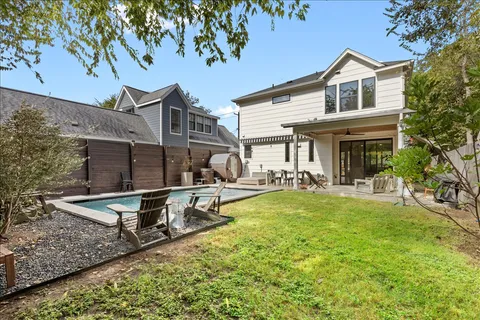 a view of a house with a small yard and potted plants