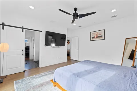 a bedroom with a bed and a flat screen tv