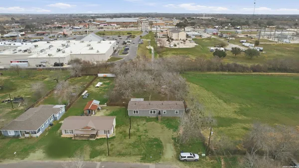 an aerial view of residential houses with outdoor space