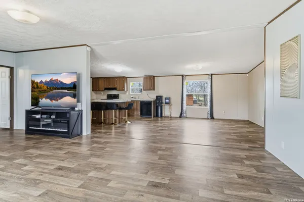 a living room with furniture and a kitchen view