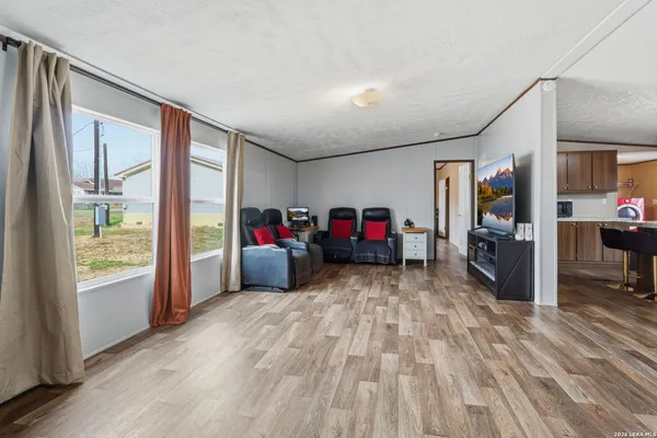 a living room filled with furniture and a floor to ceiling window
