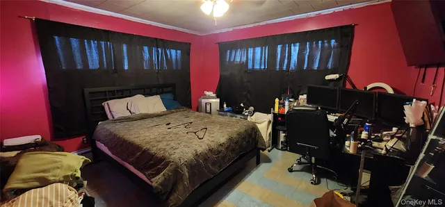 a bed sitting in a bedroom next to a window