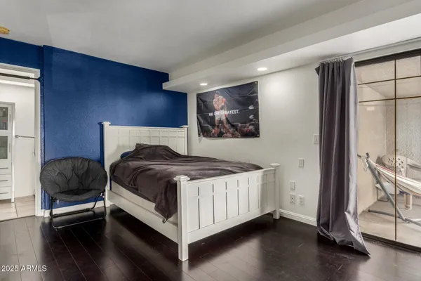 a bedroom with a bed and chair