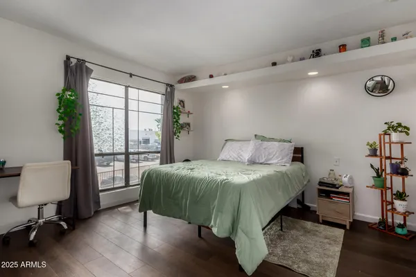 a bedroom with a bed and a window