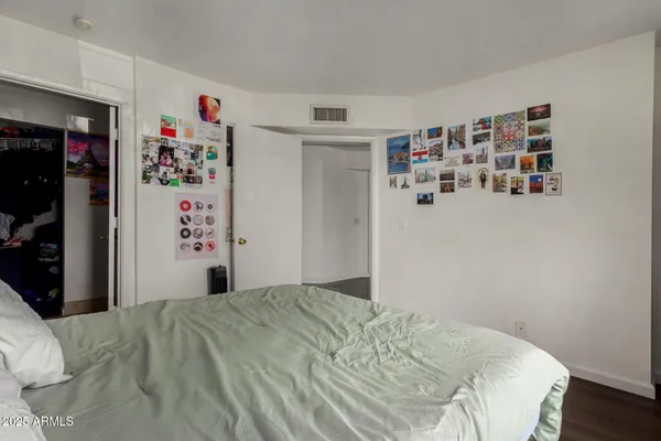 a bedroom with a bed and closet