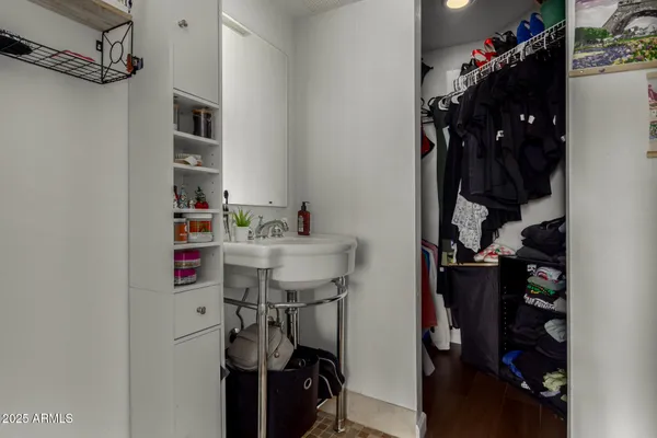 a view of walk in closet with clothes and shoes