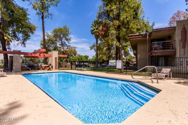 a view of a swimming pool with sitting area
