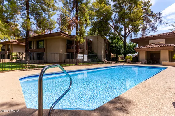 a swimming pool with outdoor seating