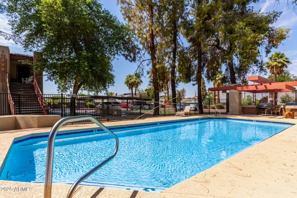 a view of swimming pool with chairs