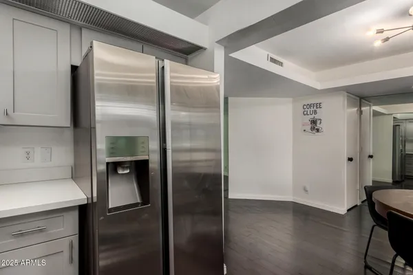 a kitchen with a refrigerator and a sink