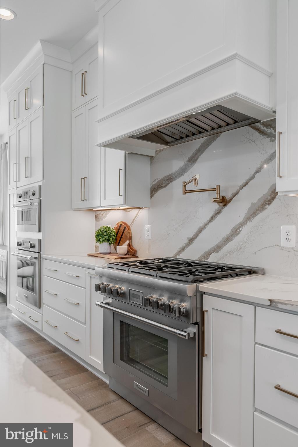 8201 River Road Bethesda, MD 20817 - Photo 13 of 50 a kitchen with granite countertop white cabinets and stainless steel appliances
