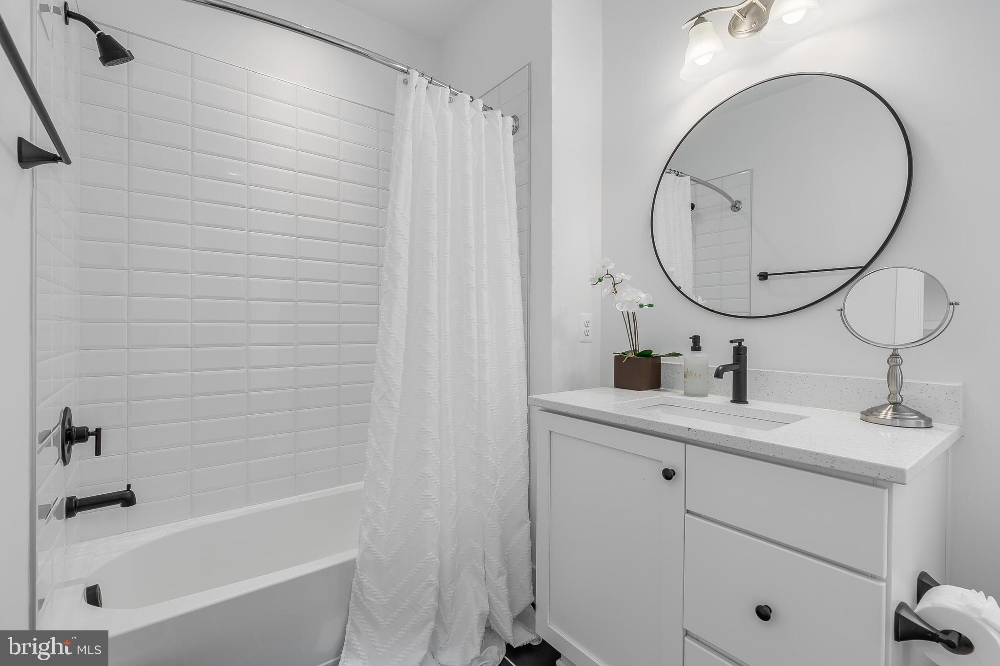 8201 River Road Bethesda, MD 20817 - Photo 24 of 50 a bathroom with a sink and a mirror