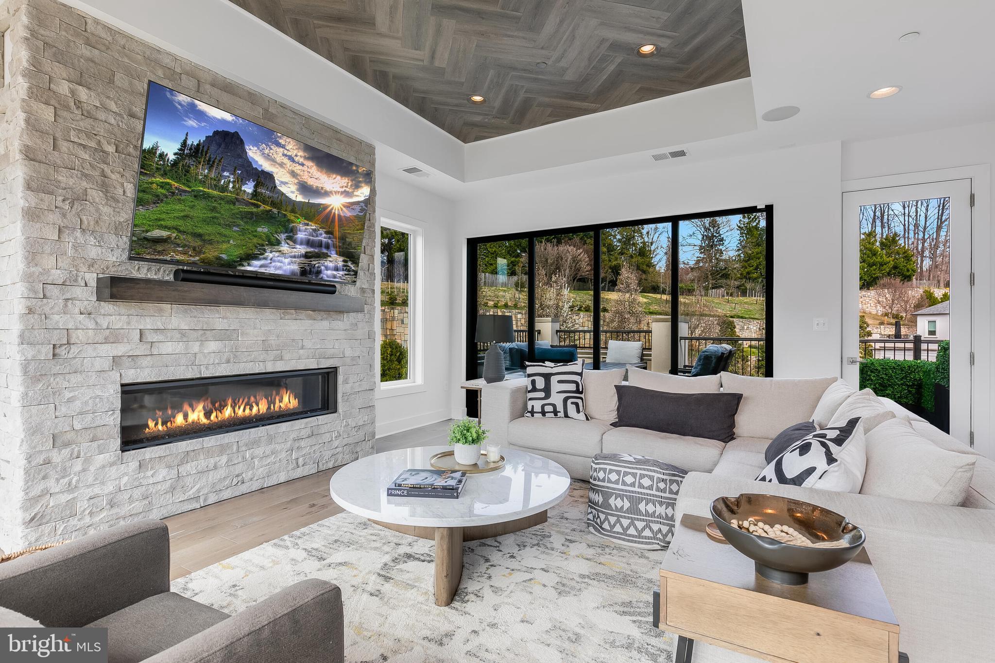 8201 River Road Bethesda, MD 20817 - Photo 29 of 50 a living room with furniture a fireplace and a flat screen tv