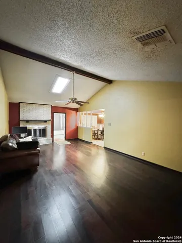 a view of a livingroom with furniture and a window