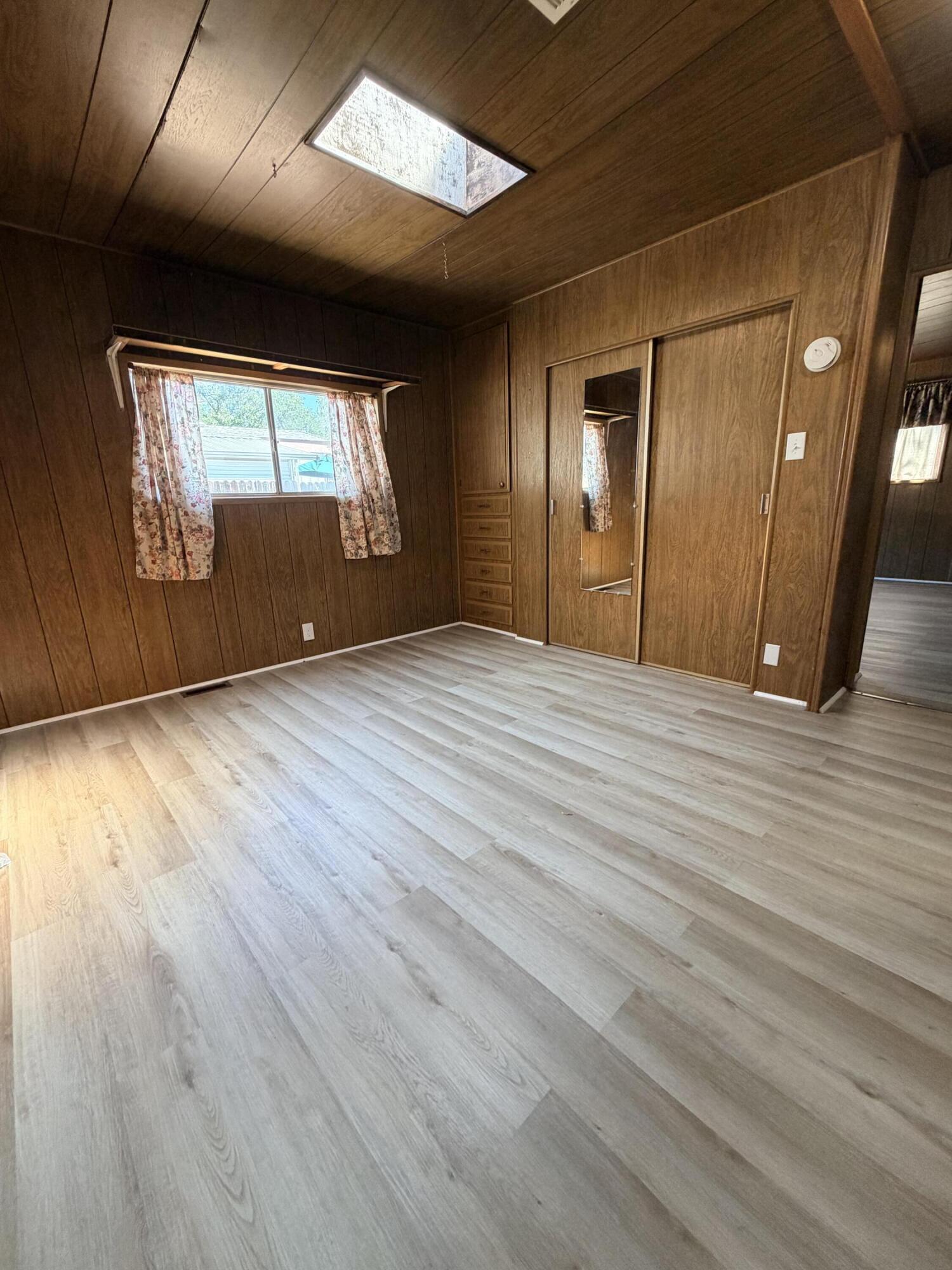 1449 Menomenee Lane, Unit 252 Redding, CA 96003 - Photo 17 of 18 a view of an empty room with wooden floor and windows