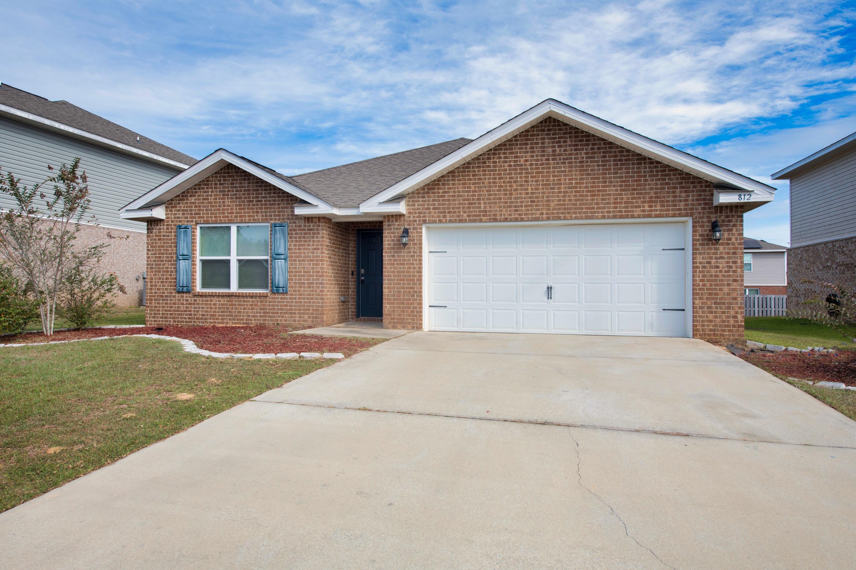 812 Moorhen Way Crestview, FL 32539 - Photo 1 of 22 a view of garage yard with garage