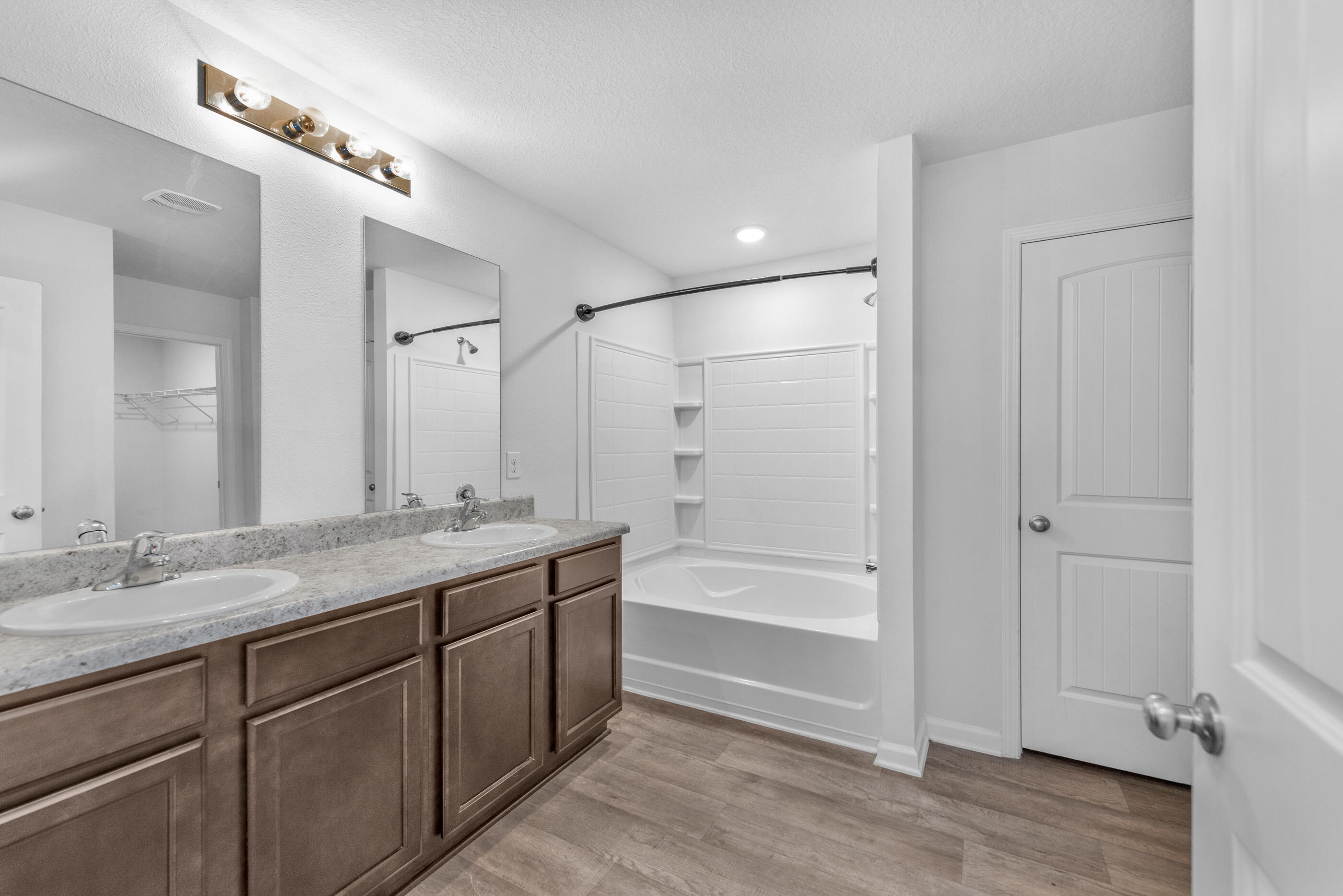 812 Moorhen Way Crestview, FL 32539 - Photo 14 of 22 a bathroom with a granite countertop sink a mirror and a bathtub