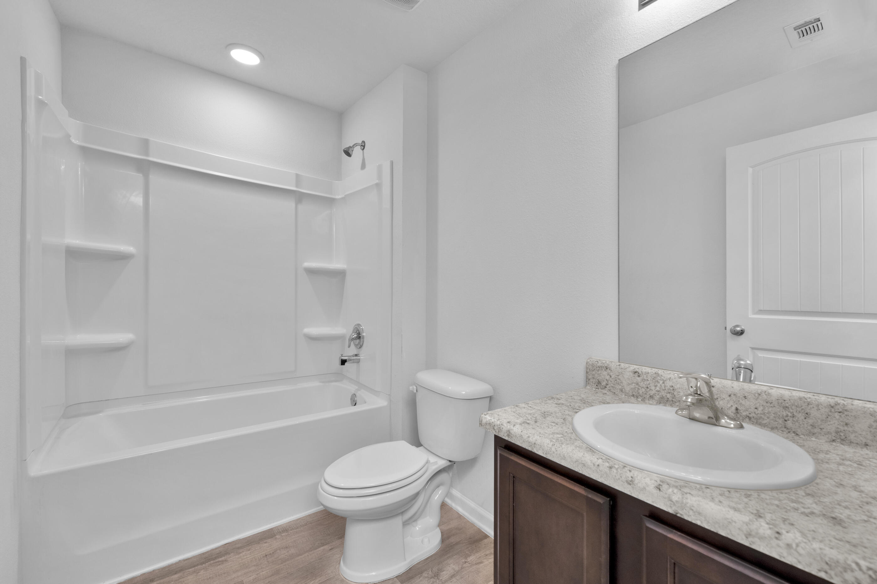 812 Moorhen Way Crestview, FL 32539 - Photo 18 of 22 a bathroom with a granite countertop sink toilet and shower