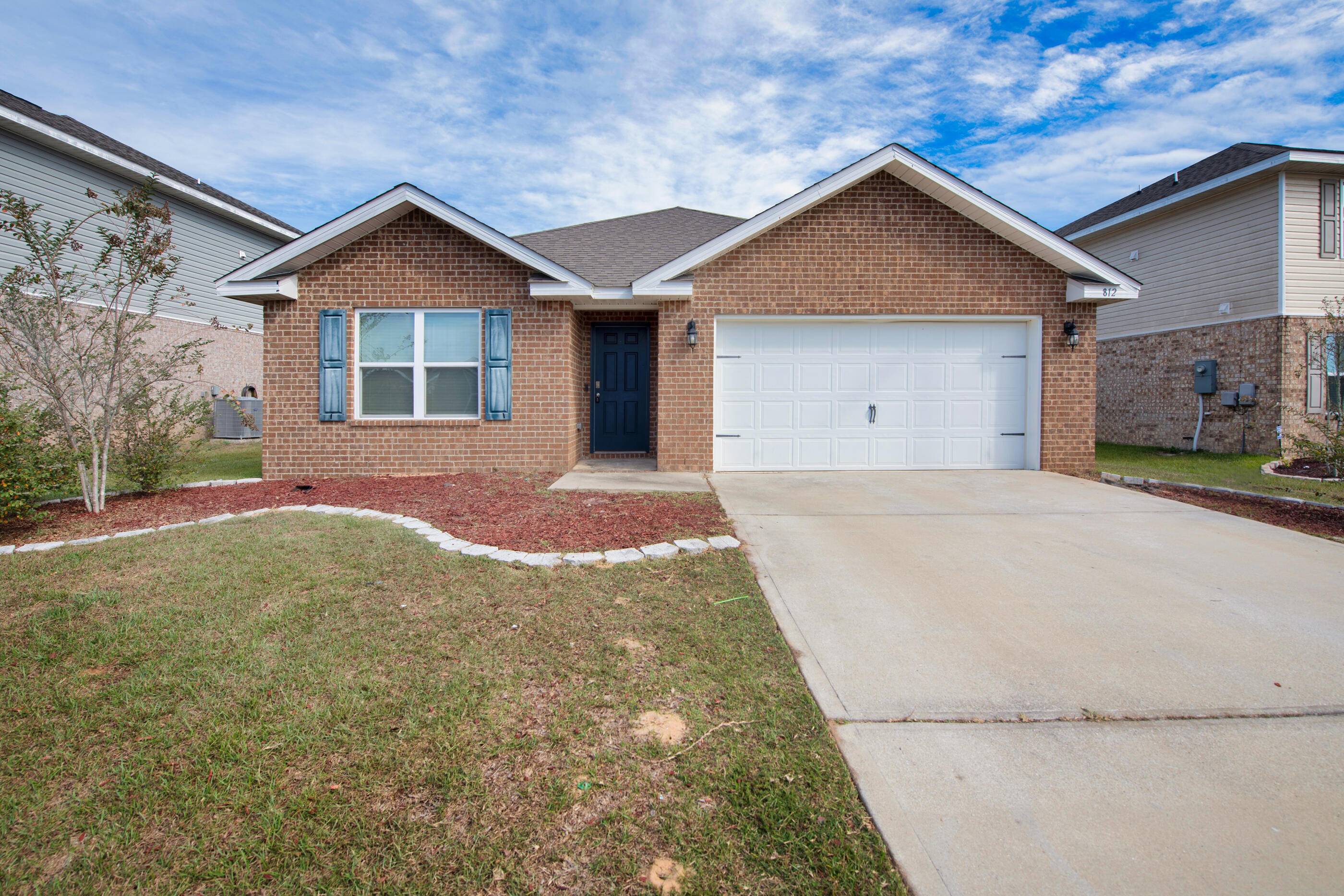 812 Moorhen Way Crestview, FL 32539 - Photo 2 of 22 a front view of a house with a yard and garage
